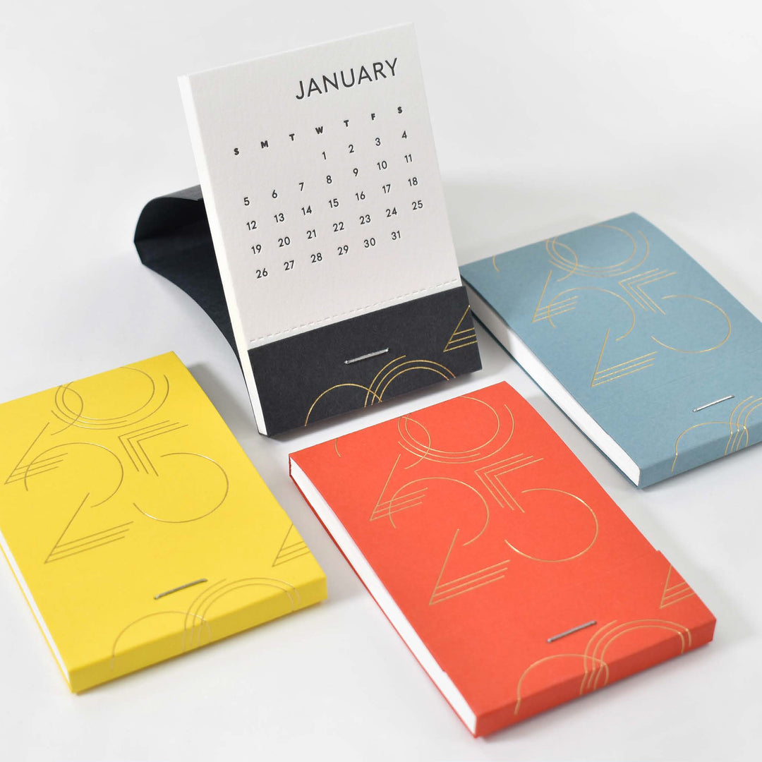 Matchbook calendars in four different paper colors