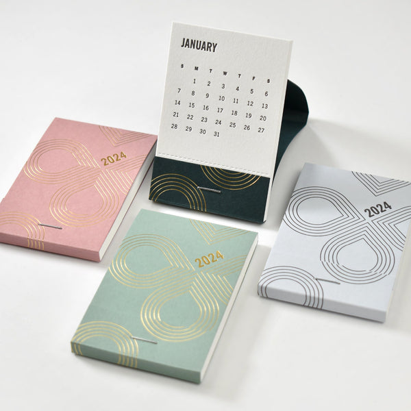 Matchbook calendars in four different paper colors